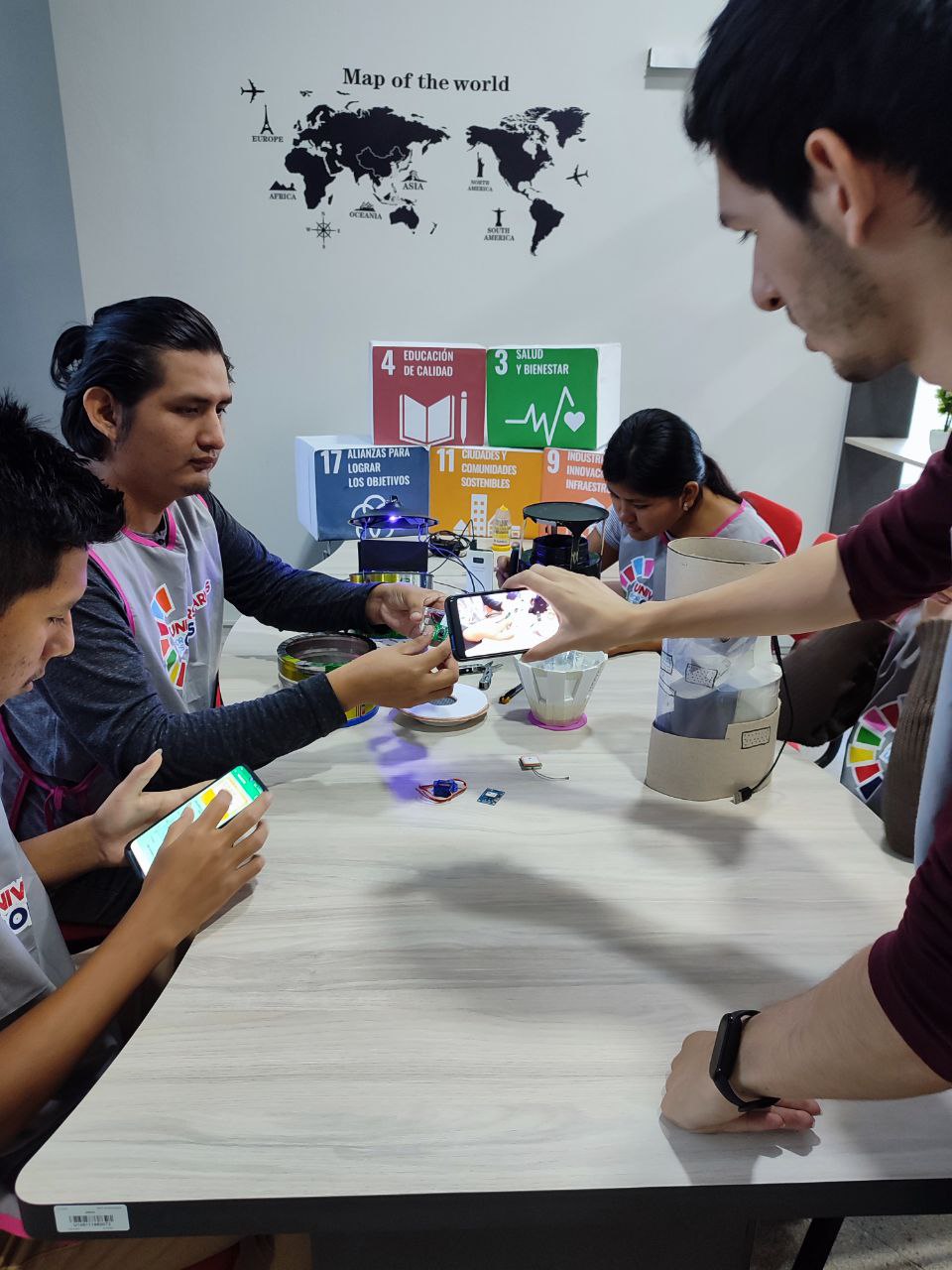 Team assembling the mosquito trap prototype with sensors and phones